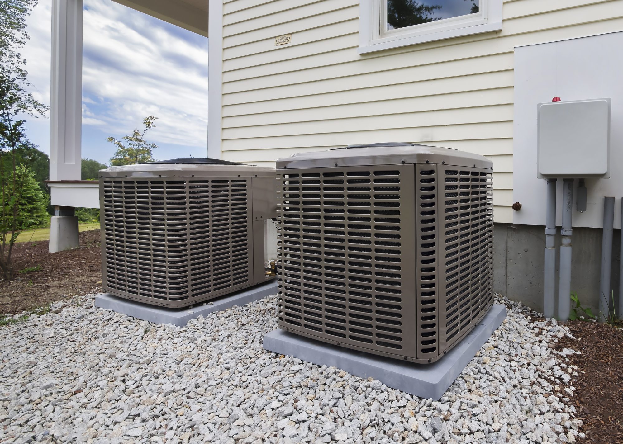 Dual Air Conditioners Air Conditioners on a stone patch