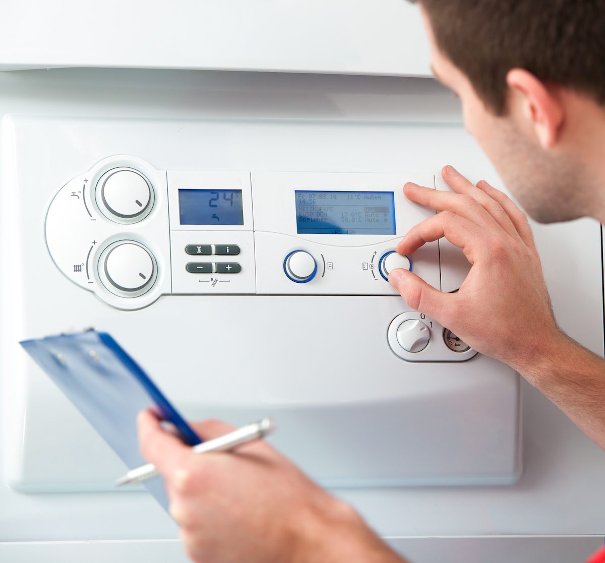 Technician servicing heating boiler Gas Boiler Service